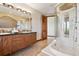 Bathroom boasting dual sinks, soaking tub, and glass shower at 1175 Ridge Oaks Dr, Castle Rock, CO 80104