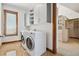 Functional laundry room with stainless steel appliances and ample storage at 1175 Ridge Oaks Dr, Castle Rock, CO 80104