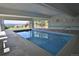 Indoor swimming pool with mountain views and glass doors to the outside at 1175 Ridge Oaks Dr, Castle Rock, CO 80104