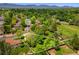 Lush property featuring mature trees, green grass, and mountain views in a desirable neighborhood at 6544 Alkire Ct, Arvada, CO 80004