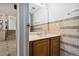 Bathroom featuring vanity with sink and colorful tile detail on the wall at 6544 Alkire Ct, Arvada, CO 80004