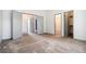 Spacious bedroom featuring neutral carpeting, multiple doorways, and ample closet space at 6544 Alkire Ct, Arvada, CO 80004