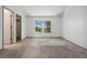 Bright bedroom with a large window showcasing lush trees and a neutral carpet at 6544 Alkire Ct, Arvada, CO 80004