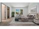 Bright bedroom featuring large window, neutral carpet, and coordinated furnishings at 6544 Alkire Ct, Arvada, CO 80004