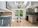 Bright dining area with skylights, chandelier, and views of the backyard at 6544 Alkire Ct, Arvada, CO 80004
