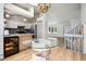 Open floor plan dining area with eat-in kitchen, and grand staircase at 6544 Alkire Ct, Arvada, CO 80004