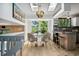 Charming dining area with bar, bright natural light, and modern chandelier, perfect for intimate gatherings at 6544 Alkire Ct, Arvada, CO 80004