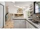 Eat-in kitchen area with granite counters, undermount sink, and staircase at 6544 Alkire Ct, Arvada, CO 80004