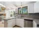 Eat-in kitchen area with granite counters and stainless steel dishwasher at 6544 Alkire Ct, Arvada, CO 80004