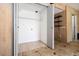 Tiled laundry room featuring washer/dryer hookups and white shelving for ample storage at 6544 Alkire Ct, Arvada, CO 80004