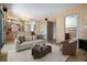 Open-concept living room with comfortable seating and a grand staircase to the dining area at 6544 Alkire Ct, Arvada, CO 80004