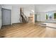 Inviting living room featuring hardwood floors, a staircase, and a large window offering ample natural light at 6544 Alkire Ct, Arvada, CO 80004