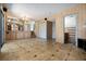 Spacious living room with views of kitchen, grand staircase, and access to the main bedroom at 6544 Alkire Ct, Arvada, CO 80004