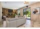 Cozy living room featuring a stone fireplace and sliding glass door to the backyard at 6544 Alkire Ct, Arvada, CO 80004