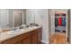 Bathroom showcasing double sinks, a spacious vanity, and a separate shower and closet area at 14341 E Tennessee Ave # 203, Aurora, CO 80012