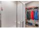 Modern shower stall and a glimpse into the closet with organized storage solutions at 14341 E Tennessee Ave # 203, Aurora, CO 80012