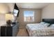 Bright bedroom with a large window, dresser, and comfortable bed; perfect for relaxation at 14341 E Tennessee Ave # 203, Aurora, CO 80012