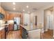 Island in kitchen with granite countertops, stainless appliances and seating and wood cabinets at 14341 E Tennessee Ave # 203, Aurora, CO 80012