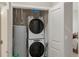Conveniently located laundry area with stacked washer and dryer and extra storage space at 14341 E Tennessee Ave # 203, Aurora, CO 80012