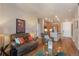 Cozy living room featuring plush seating, hardwood floors, and an open layout to the kitchen at 14341 E Tennessee Ave # 203, Aurora, CO 80012
