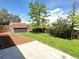 View of the backyard, showing a new shed, patio, and grass area with sprinkler system at 18073 E Belleview Pl, Centennial, CO 80015