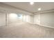 Spacious finished basement with neutral carpet and multiple storage areas at 18073 E Belleview Pl, Centennial, CO 80015