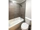 Bathroom featuring shower over tub and neutral grey tiling at 18073 E Belleview Pl, Centennial, CO 80015