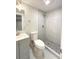 Bathroom features a new toilet, gray vanity, and a stand up shower with a tiled surround at 18073 E Belleview Pl, Centennial, CO 80015