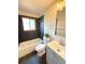 Modern bathroom with stylish vanity, gray backsplash, and shower over tub combo at 18073 E Belleview Pl, Centennial, CO 80015