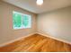 Well-lit room with hardwood floors and a large window overlooking the lush exterior at 18073 E Belleview Pl, Centennial, CO 80015