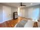 Spacious bedroom with hardwood floors, ceiling fan, and view to bath at 18073 E Belleview Pl, Centennial, CO 80015