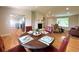 Open dining area with hardwood floors, stylish table setting, and direct access to the kitchen at 18073 E Belleview Pl, Centennial, CO 80015