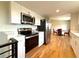 Modern kitchen with stainless steel appliances and direct access to the dining area at 18073 E Belleview Pl, Centennial, CO 80015
