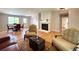 Cozy living room with hardwood floors, a fireplace, and comfortable seating arrangements at 18073 E Belleview Pl, Centennial, CO 80015