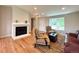 Bright living room with fireplace, neutral walls, and hardwood floors at 18073 E Belleview Pl, Centennial, CO 80015