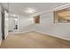 Finished basement space with neutral carpet and window with blinds provides a versatile area at 1601 Jackson St, Denver, CO 80206