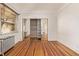 Bright bedroom with wood floors, large window, mirrored closet and vintage radiator at 1601 Jackson St, Denver, CO 80206