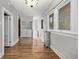 Hallway with hardwood floors, radiator, and access to the laundry area at 1601 Jackson St, Denver, CO 80206