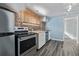 Kitchen featuring stainless steel appliances, brick wall and wooden counter at 1601 Jackson St, Denver, CO 80206