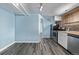 Kitchen with stainless steel appliances, brick wall and arched entry to the living room at 1601 Jackson St, Denver, CO 80206