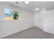 Finished basement room with gray carpet, a window and natural light and a clean white door at 1705 Cathay Ct, Aurora, CO 80011