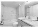 Stylish bathroom with marble tiling, modern vanity, and shower-tub combo at 1705 Cathay Ct, Aurora, CO 80011