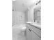Modern bathroom with marble tiling, a sleek vanity, and a shower-tub combo at 1705 Cathay Ct, Aurora, CO 80011