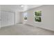 Bright and airy bedroom featuring plush carpet, two windows and a closet at 1705 Cathay Ct, Aurora, CO 80011