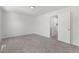 Bedroom showcasing plush carpet with a bathroom doorway, providing space and comfort at 1705 Cathay Ct, Aurora, CO 80011