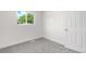 Bright bedroom featuring neutral carpet, crisp white trim, and a window view at 1705 Cathay Ct, Aurora, CO 80011