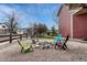 Enjoy outdoor gatherings in this backyard featuring gravel, comfortable chairs and a rustic stone fire pit at 22965 Allendale Ave, Parker, CO 80138