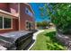 Relaxing backyard features well-kept lawn, stone flower bed surround, and outdoor seating area at 22965 Allendale Ave, Parker, CO 80138