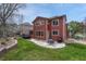 Landscaped backyard with a lush lawn, patio with grill, hot tub, and plenty of space for entertaining at 22965 Allendale Ave, Parker, CO 80138