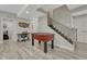 Finished basement featuring a stairway, a work station, and a foosball table for leisure and utility at 22965 Allendale Ave, Parker, CO 80138